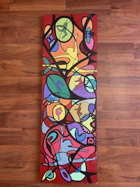 a colorful abstract painting on a wooden floor