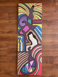 a colorful abstract painting on a wooden floor